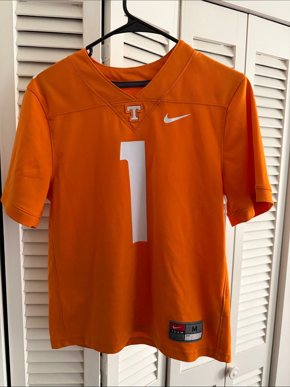 Nike Orange Youth Football Jersey with White Number and Swoosh